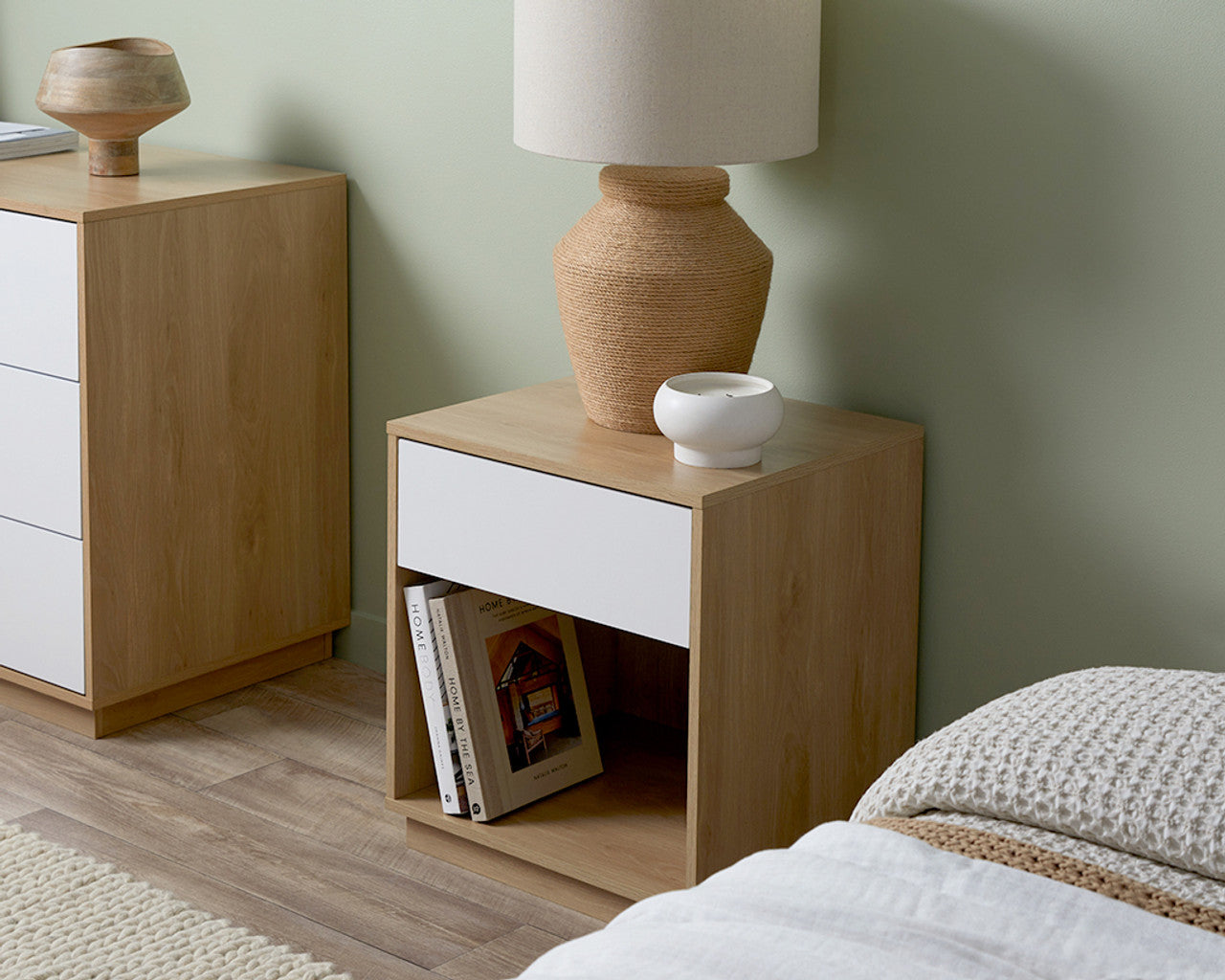 Imperial Homes coastal bedside pedestal with light wood frame and white drawer in a modern bedroom setup