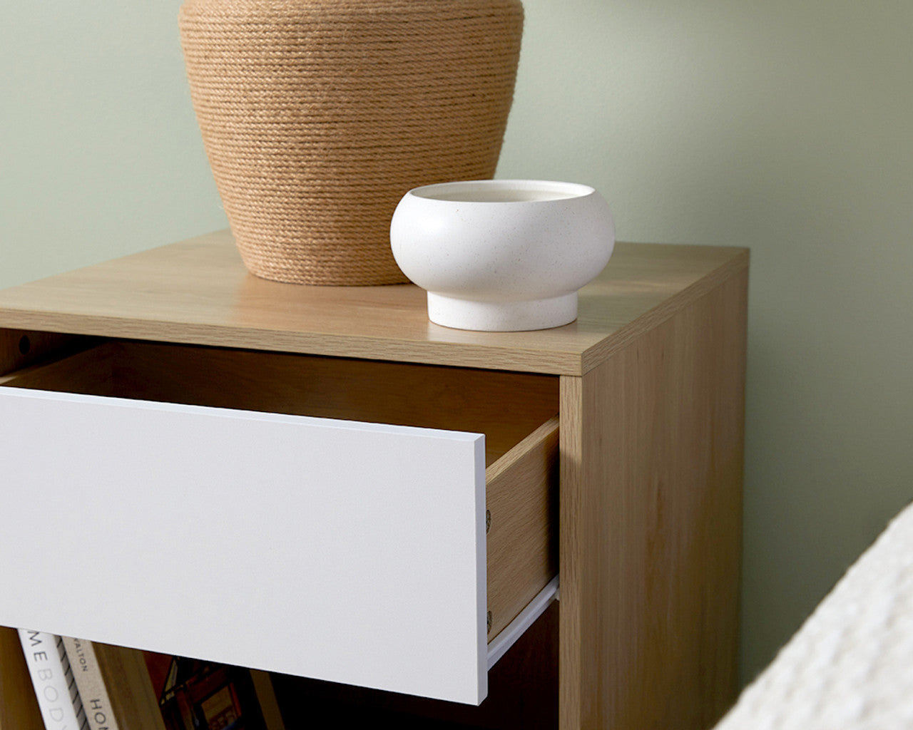Imperial Homes coastal bedside pedestal with natural wood finish and white drawer partially open