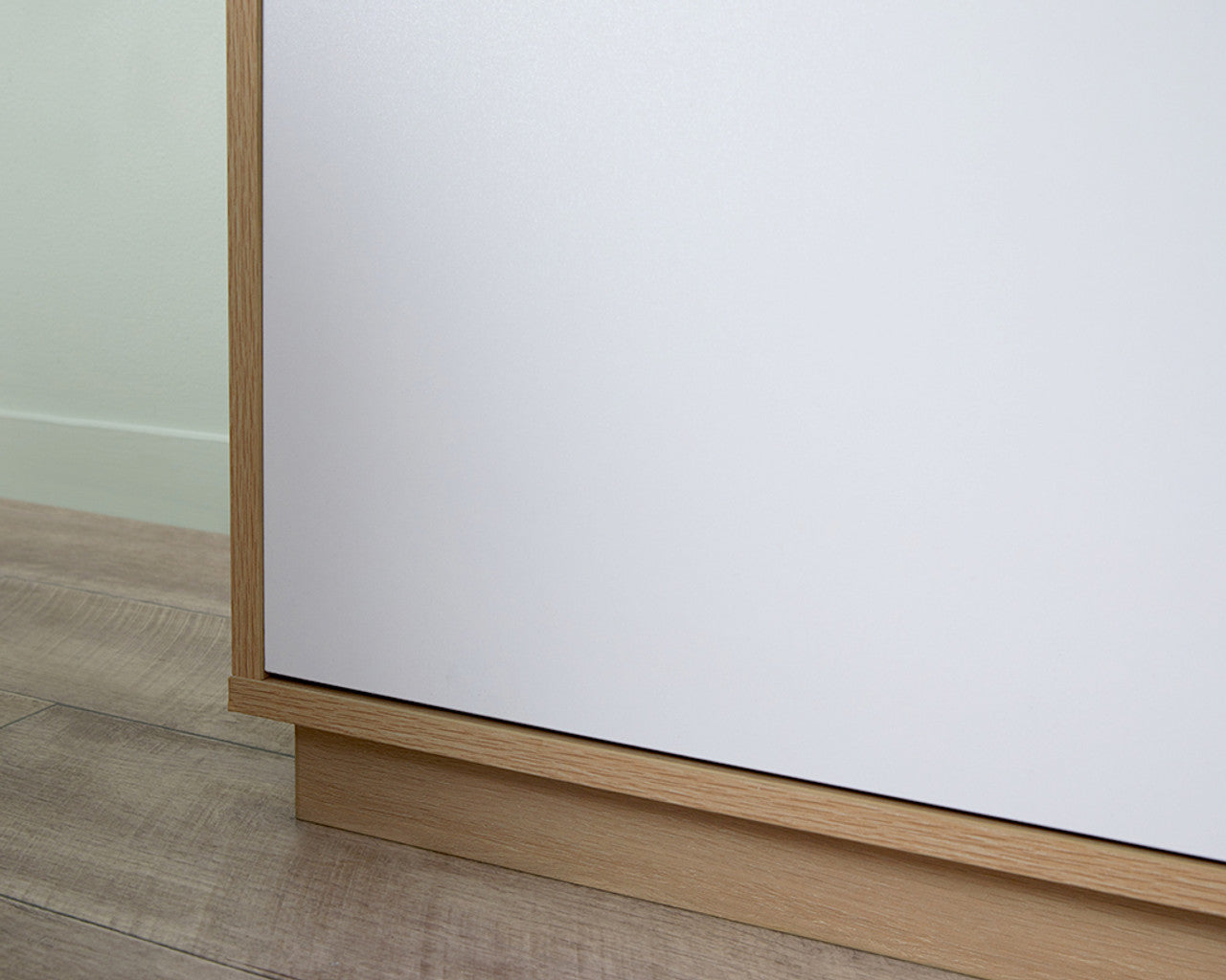 Close-up view of a coastal buffet sideboard corner with wood frame and white panel by Imperial Homes