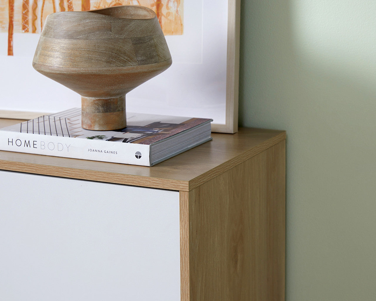 Imperial Homes coastal buffet sideboard with wood finish topped with decorative sculpture and book