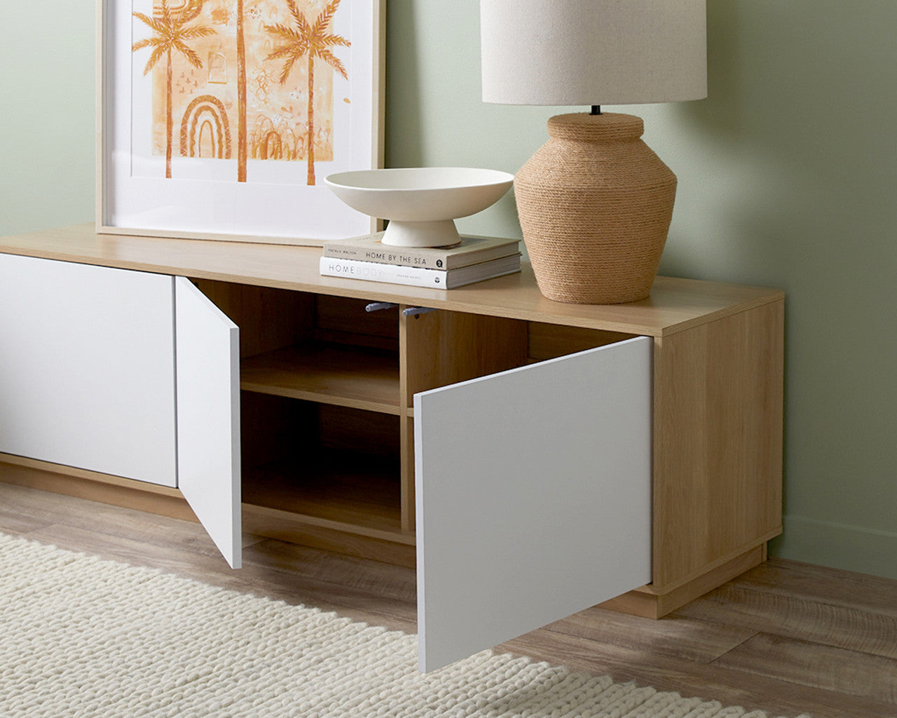 Imperial Homes coastal TV unit with white doors and natural wood finish, styled with lamp and decorative items