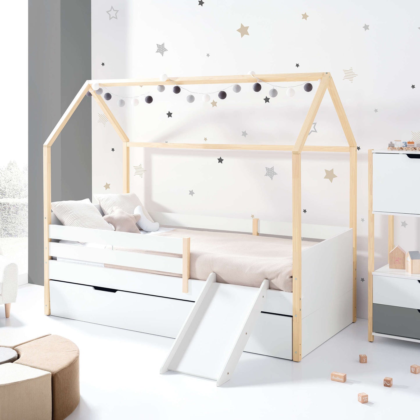 Imperial Homes House Teepee Bed with wooden frame and slide in a kid's star-themed bedroom