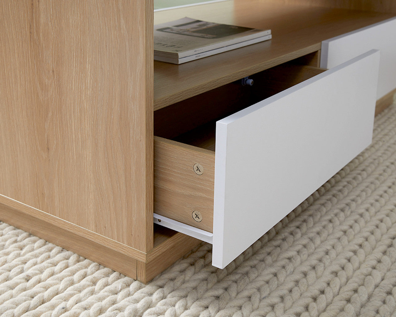 Imperial Homes modern minimalist coffee table with white drawer and wooden finish on knitted cream rug
