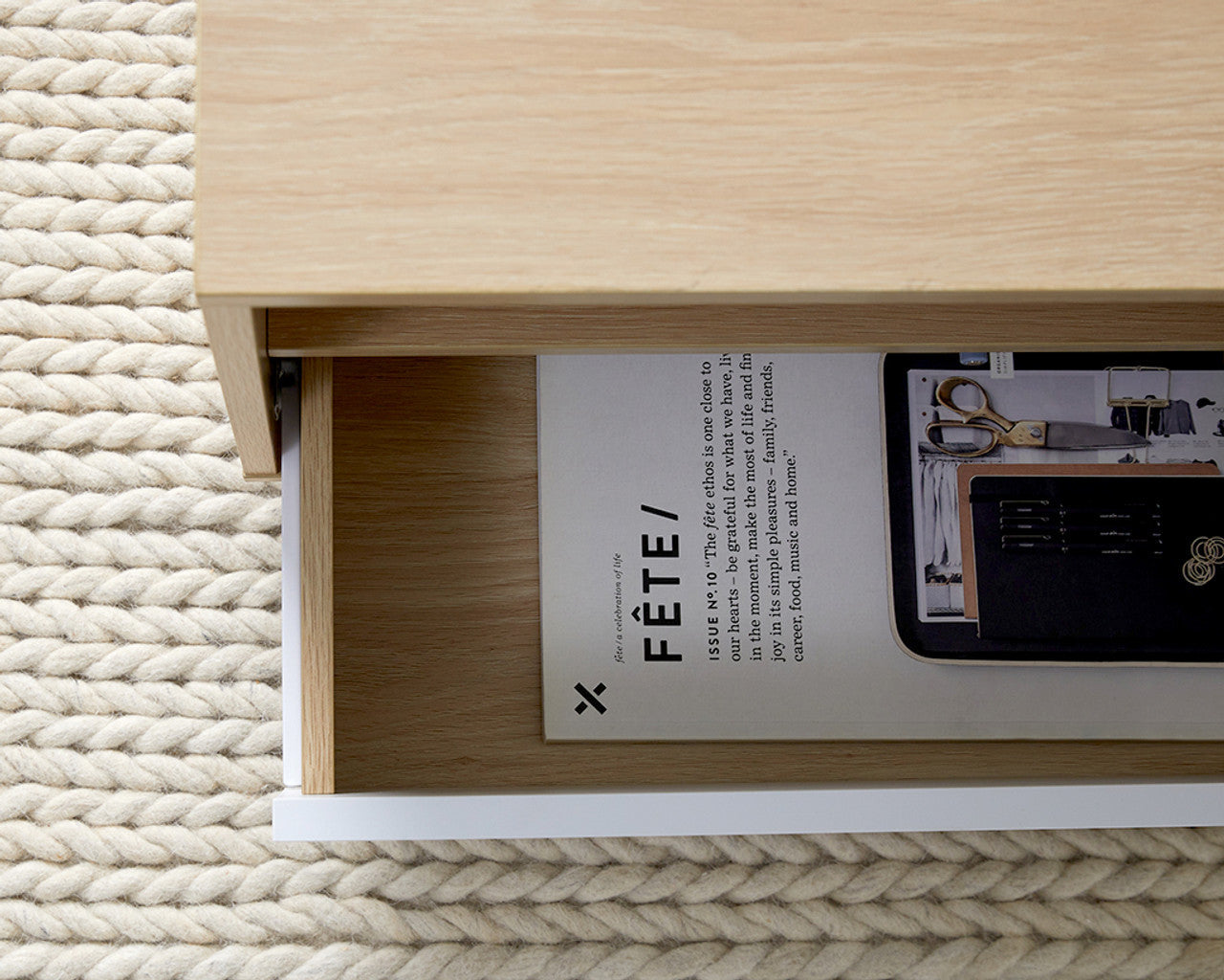 Imperial Homes modern minimalist coffee table drawer open showing magazines on textured rug