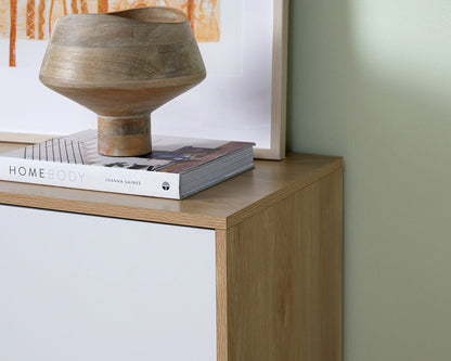 Imperial Homes coastal buffet sideboard with wood finish topped with decorative sculpture and book