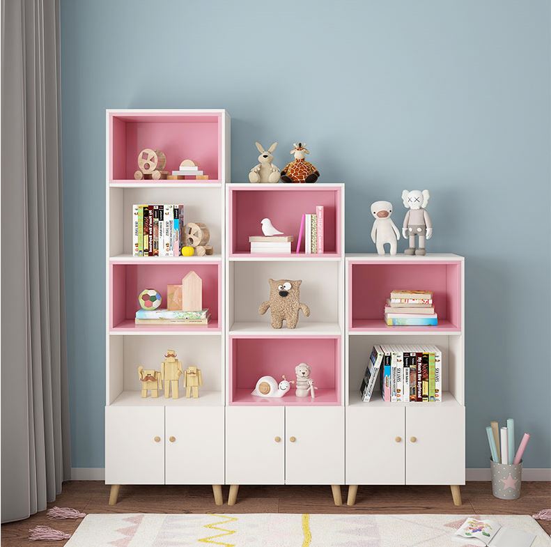 Imperial Homes modern bookshelf with cabinets in white and pink holding toys and books in a living room
