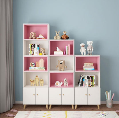 Imperial Homes modern bookshelf with cabinets in white and pink holding toys and books in a living room