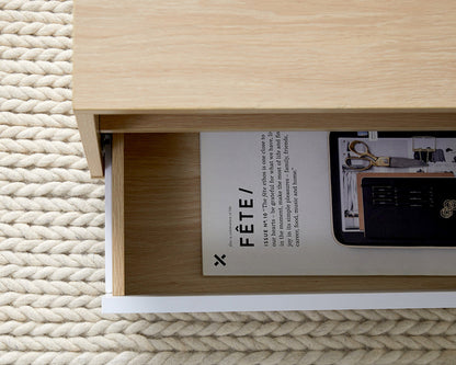 Imperial Homes modern minimalist coffee table drawer open showing magazines on textured rug