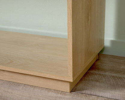 Close-up of light wood coastal console table corner showing smooth finish and craftsmanship